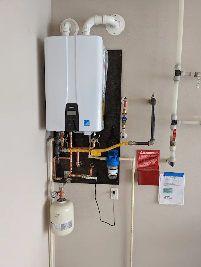 Professional plumber installing copper piping in a Farragut home